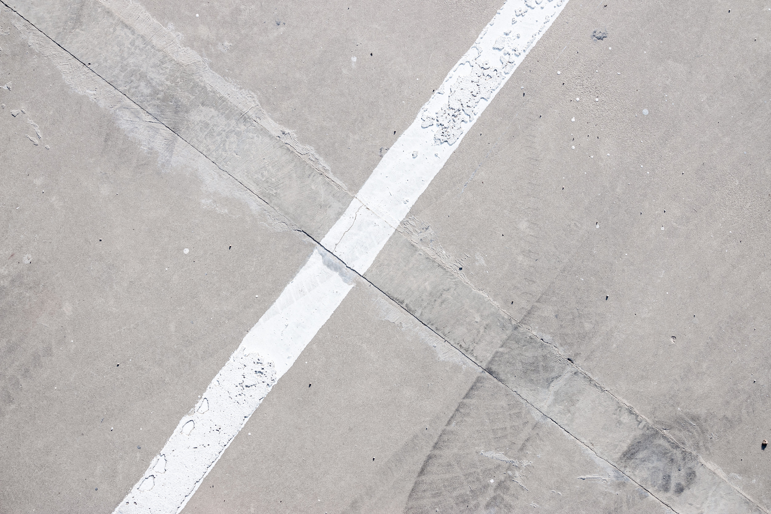 Croix blanche sur sol bétonné usé